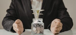 A professional financial advisor sitting across a table from a client couple in a warm, collaborative meeting room, focusing on a financial plan rather than investment charts to represent stewardship.