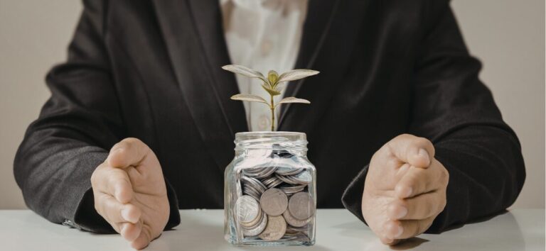 A professional financial advisor sitting across a table from a client couple in a warm, collaborative meeting room, focusing on a financial plan rather than investment charts to represent stewardship.