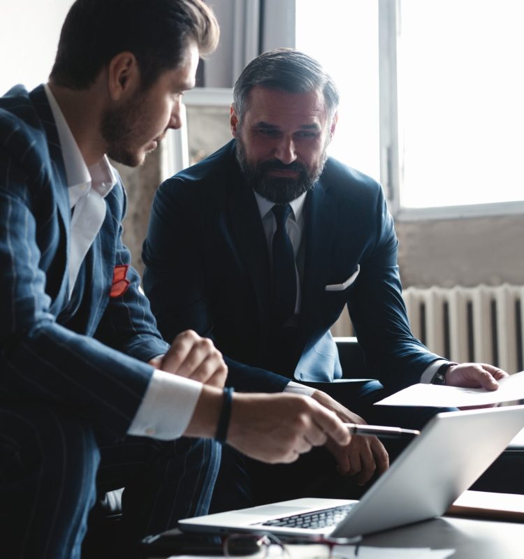 Business executives discussing work, developing strategy for online business, explaining sharing ideas, preparing presentation, having brainstorming session at office.